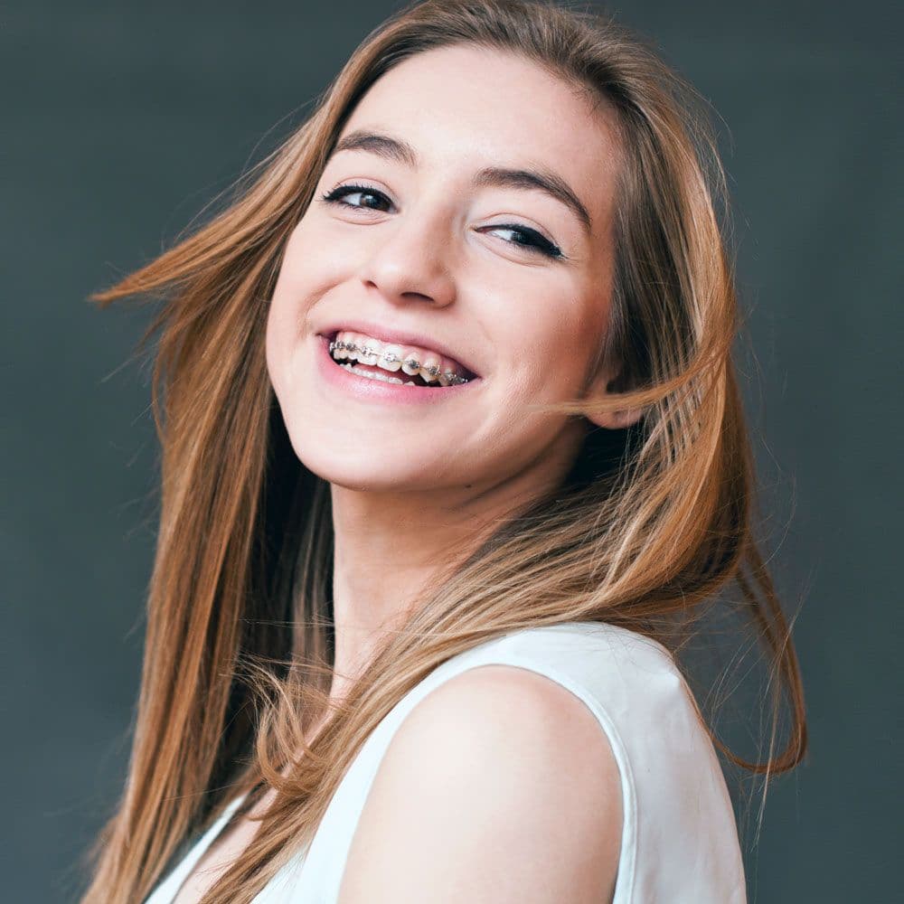 A girl smiling with braces